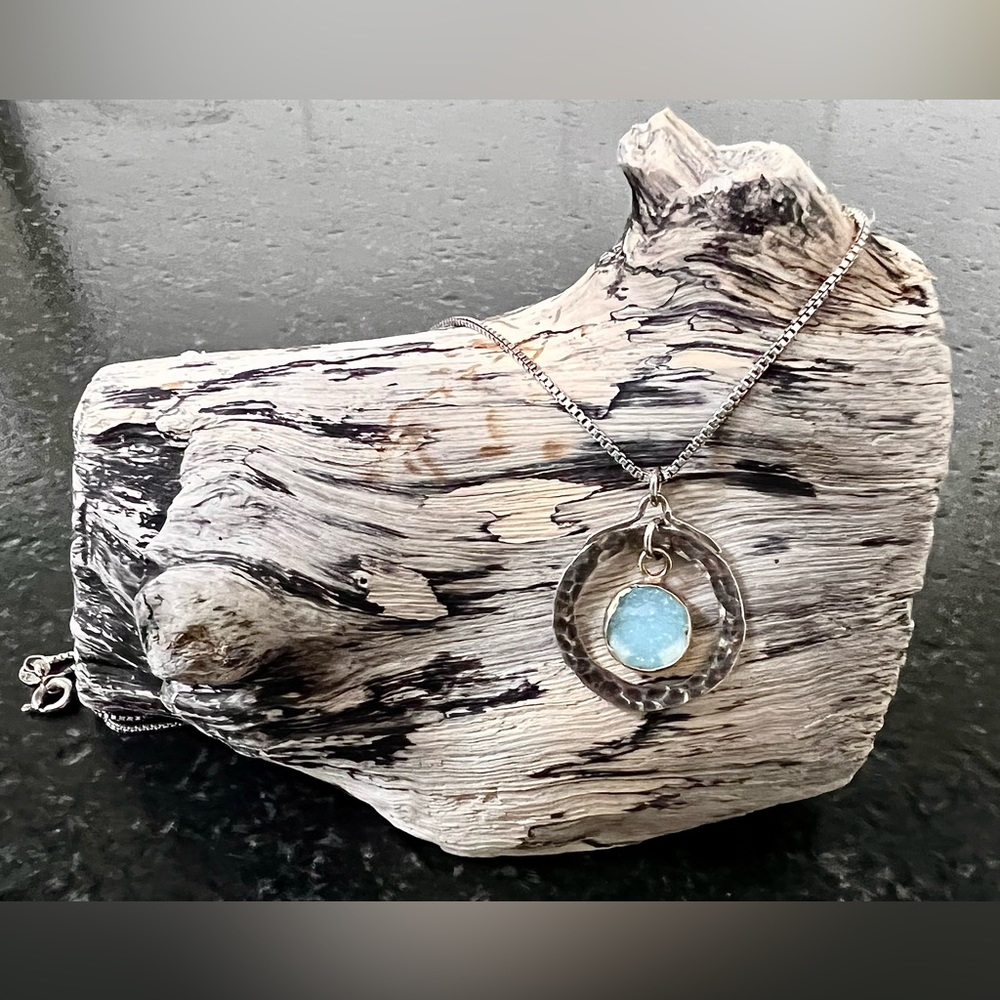 Blue geode set in copper and surrounded by a sterling silver disc w/chain.